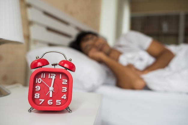 Free photo lazy man waking up in his bedroom