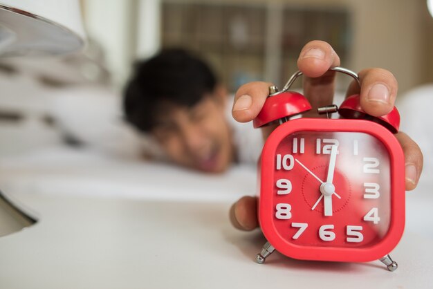 Lazy Man waking up in his bedroom