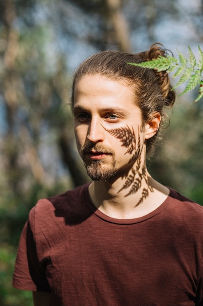 Leaf casting a shadow on man