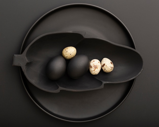 Leaf shaped dark plate with eggs on a dark plate