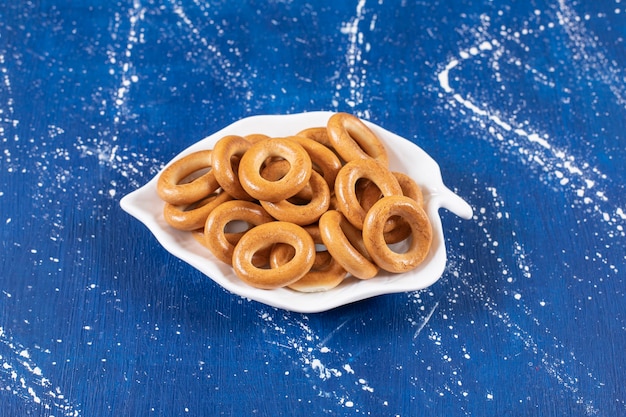 Leaf-shaped plate of salted round pretzels placed on colorful plate