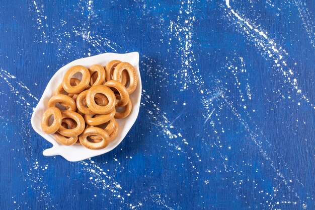 Leaf-shaped plate of salted round pretzels placed on colorful plate