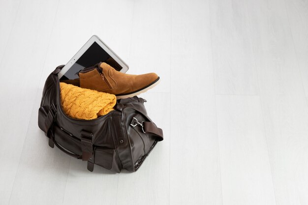 Leather bag packed with shoe and tablet