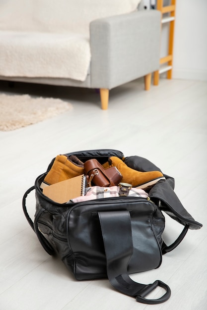 Leather bag packed with shoes and camera