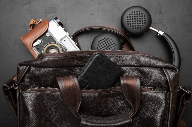 Leather bag for travel with headphones and camera