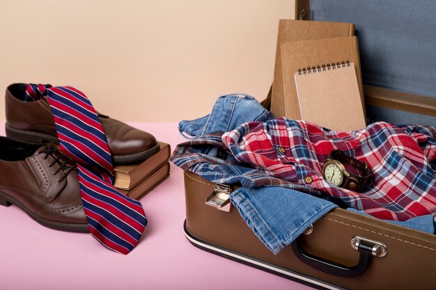 Leather suitcase packed with shoes and clothes