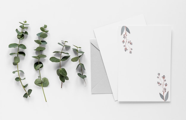 Leaves branches beside wedding card
