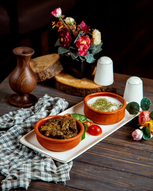 Leaves dolma with yogurt on plate