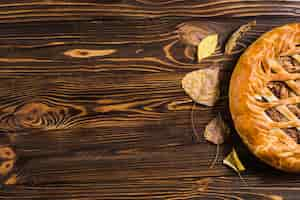 Free photo leaves and pie on table