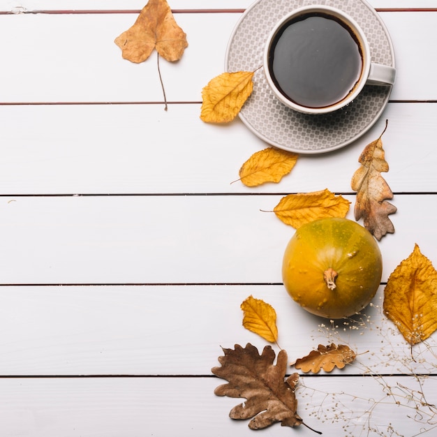 Leaves and squash near drink