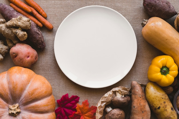 Leaves and vegetables lying around plate