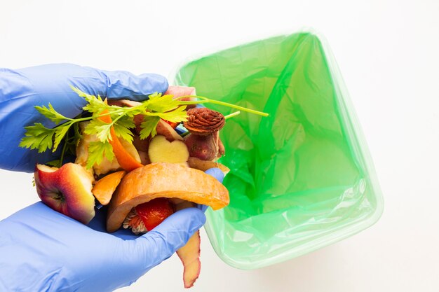 Leftover wasted food and person wearing gloves