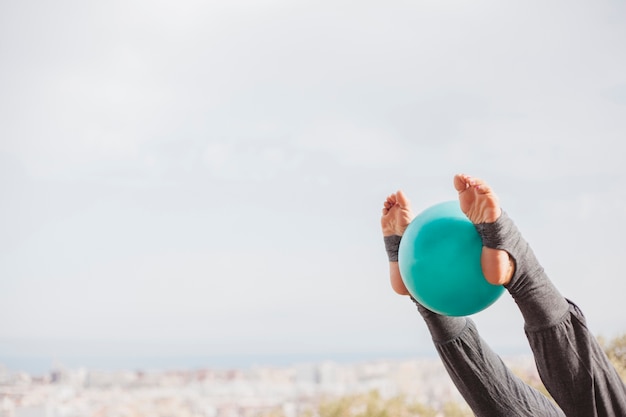 Free photo leg view woman doing exercise with ball