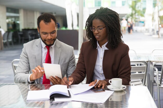 Legal expert taking notes on contract draft