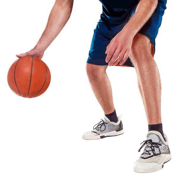 The legs of a basketball player with ball