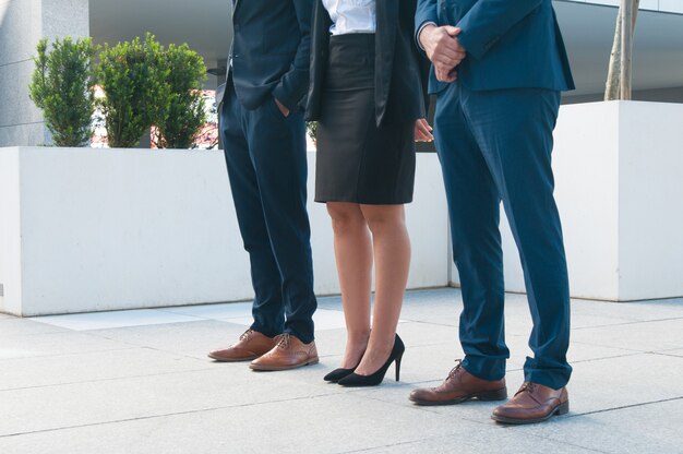 Legs of business people standing on piled porch