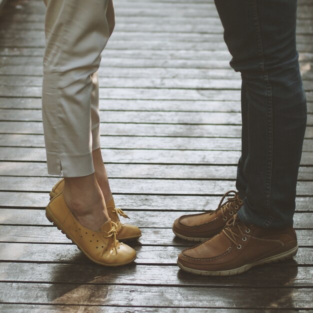 Legs of a couple and woman on tiptoe