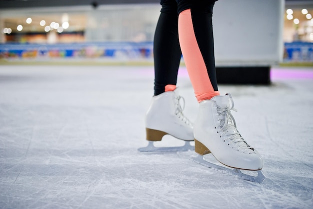 Legs of ice skater on the ice rink