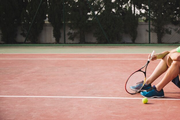 Legs of sitting tennis player