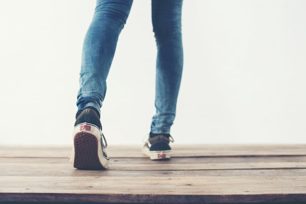 Legs walking backward and blue shoes