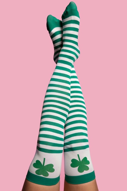 Legs wearing socks with clovers motif
