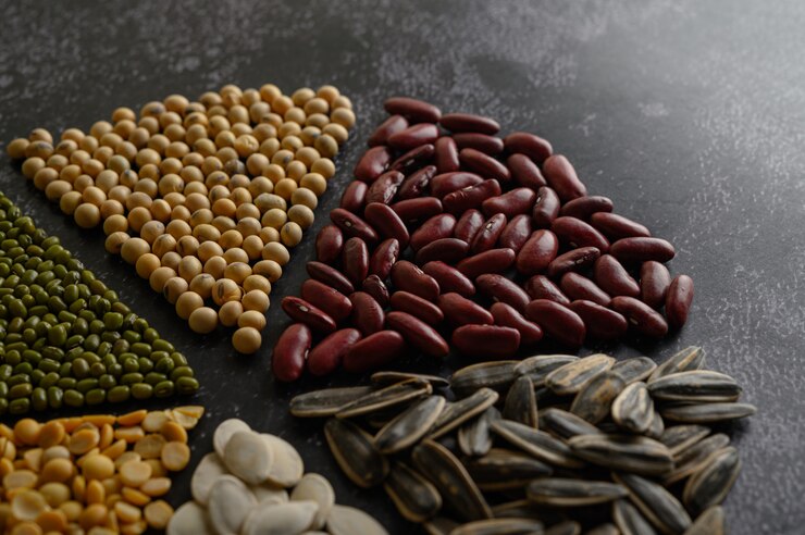 Free Photo legumes arranged in a circle on the black cement floor.