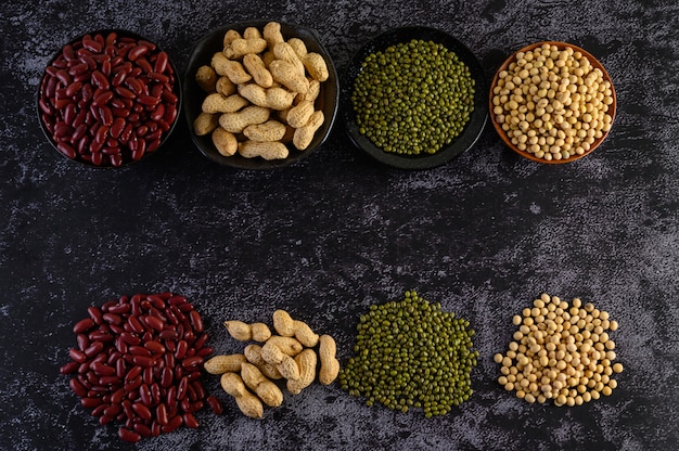 Free photo legumes, and beans assortment on the black cement floor.