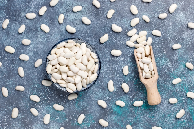 Free photo legumes and beans assortment in different bowls on light stone surface . top view. healthy vegan protein food.