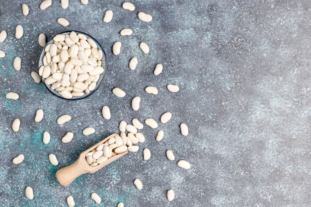 Free photo legumes and beans assortment in different bowls on light stone surface . top view. healthy vegan protein food.