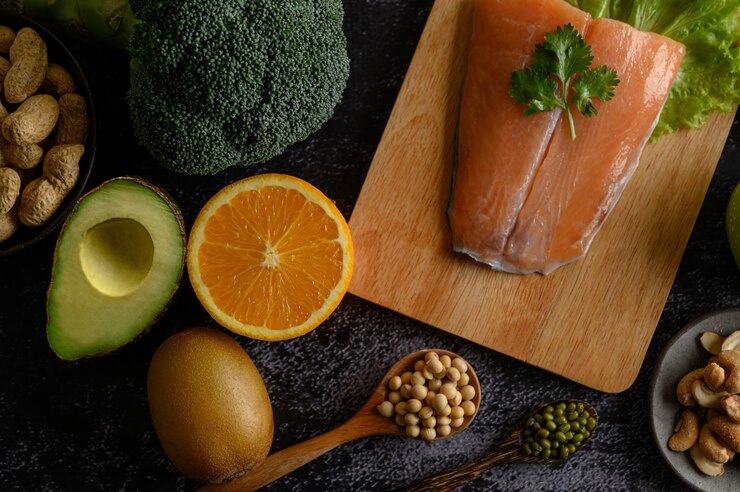 Free Photo legumes, fruit, and salmon fish pieces on a wooden chopping board.
