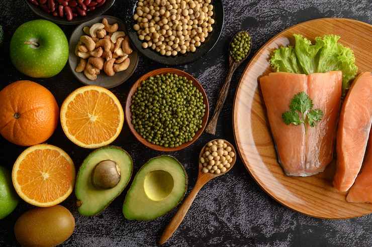 Free Photo legumes, fruit and salmon pieces on a wooden plate.