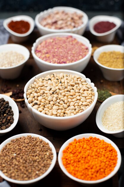 Legumes and spices in white bowls