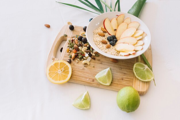 Lemon; dryfruits and oatmeals on white background