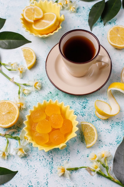 Lemon jelly candies with fresh lemons ,top view