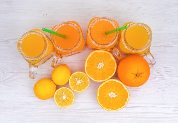 Lemon and orange juice top view on  surface