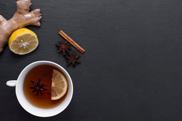 Lemon tea with ginger and cinnamon beside