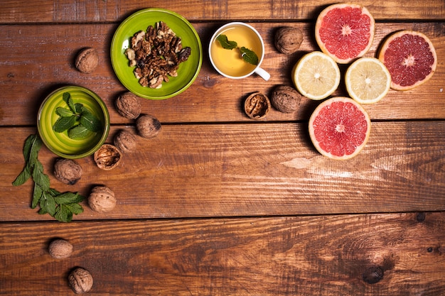 Lemon and walnut on a wooden surface close up