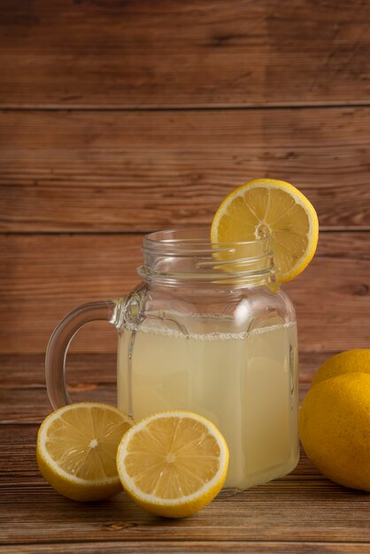 Lemonade in a glass cup on the wooden table