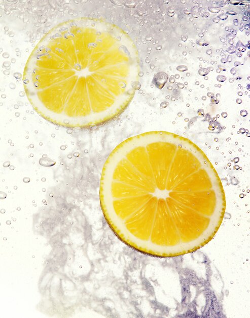 Lemons dropped into water