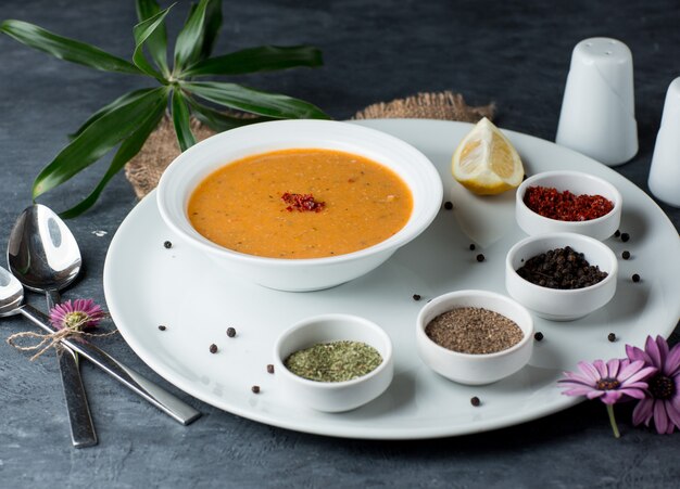 lentil soup served with lemon, sumac, black pepper balls and dried mint