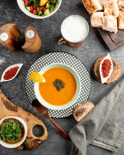 Lentil soup served with slice of lemon