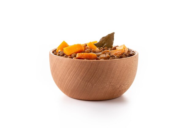 Lentil stew ragout with pumpkin and carrot in bowl isolated on white background