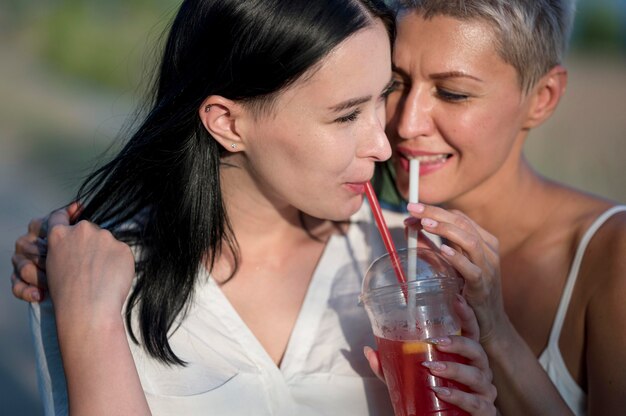 Lesbian couple drinking juice