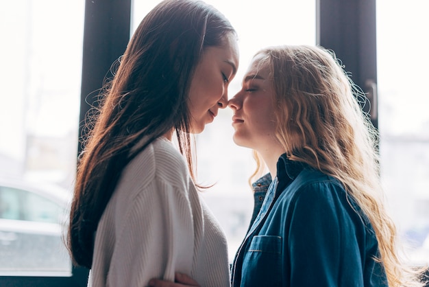 Lesbian couple gathered kissing