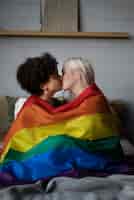 Free photo lesbian couple kiss with lgbt flag