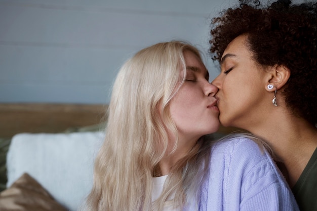 Lesbian couple kissing with copy space