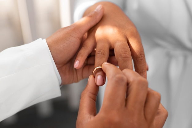 Free photo lesbian couple showing off their golden wedding rings