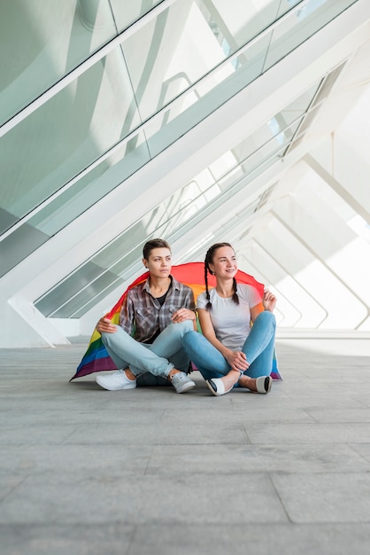 Lesbian couple sitting on paving stone