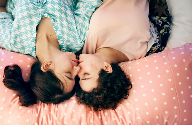 Lesbian couple sleeping on the bed together