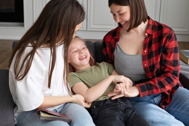 Lesbian couple spending time with their daughter at home